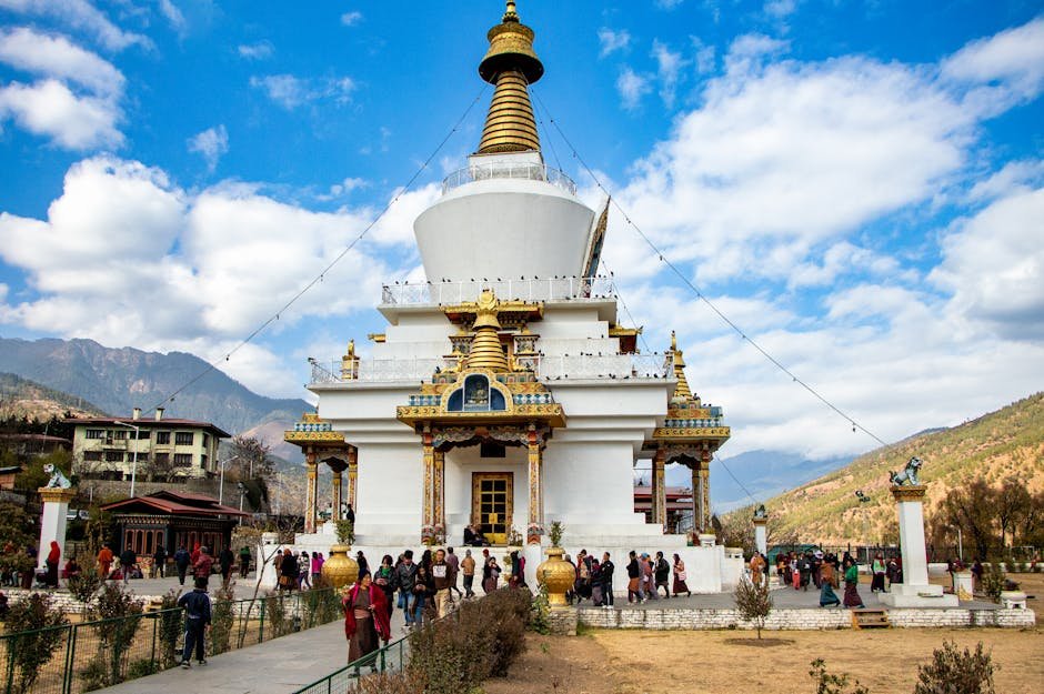 A vibrant view of Memorial Chorten, a religious landmark in Thimphu, Bhutan, surrounded by visitors.